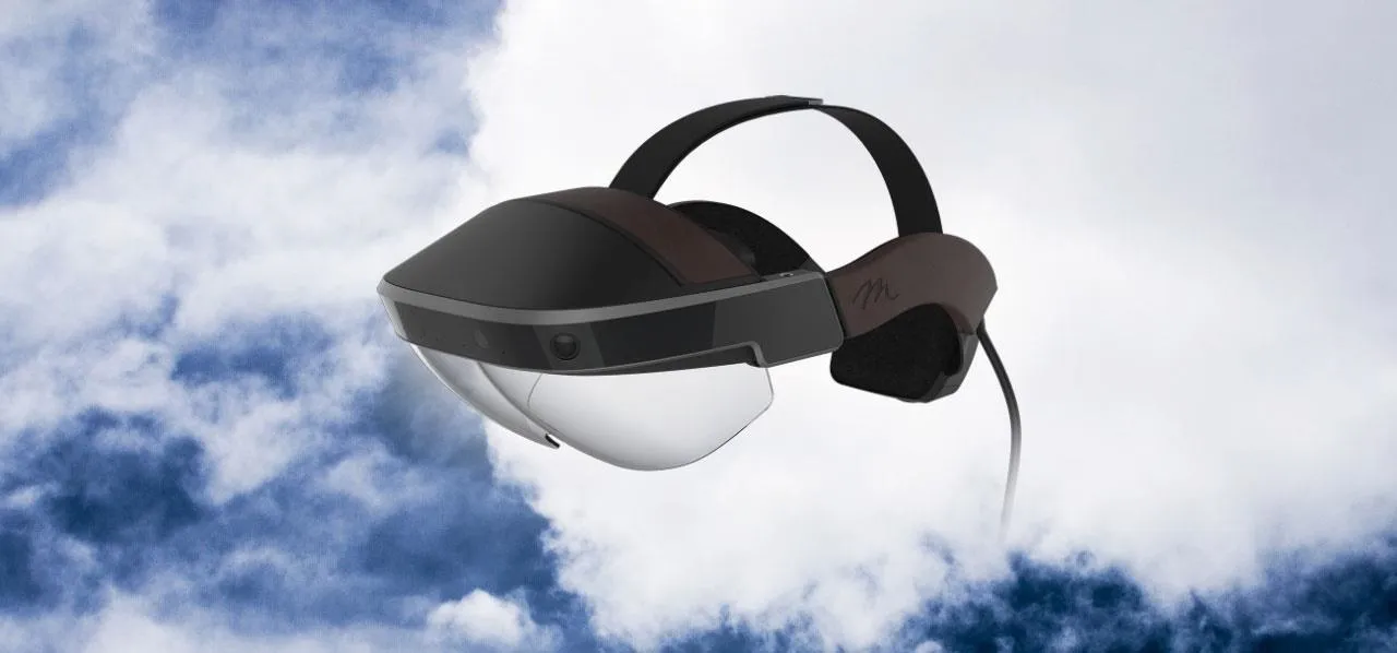Virtual reality headset against a cloudy sky background.