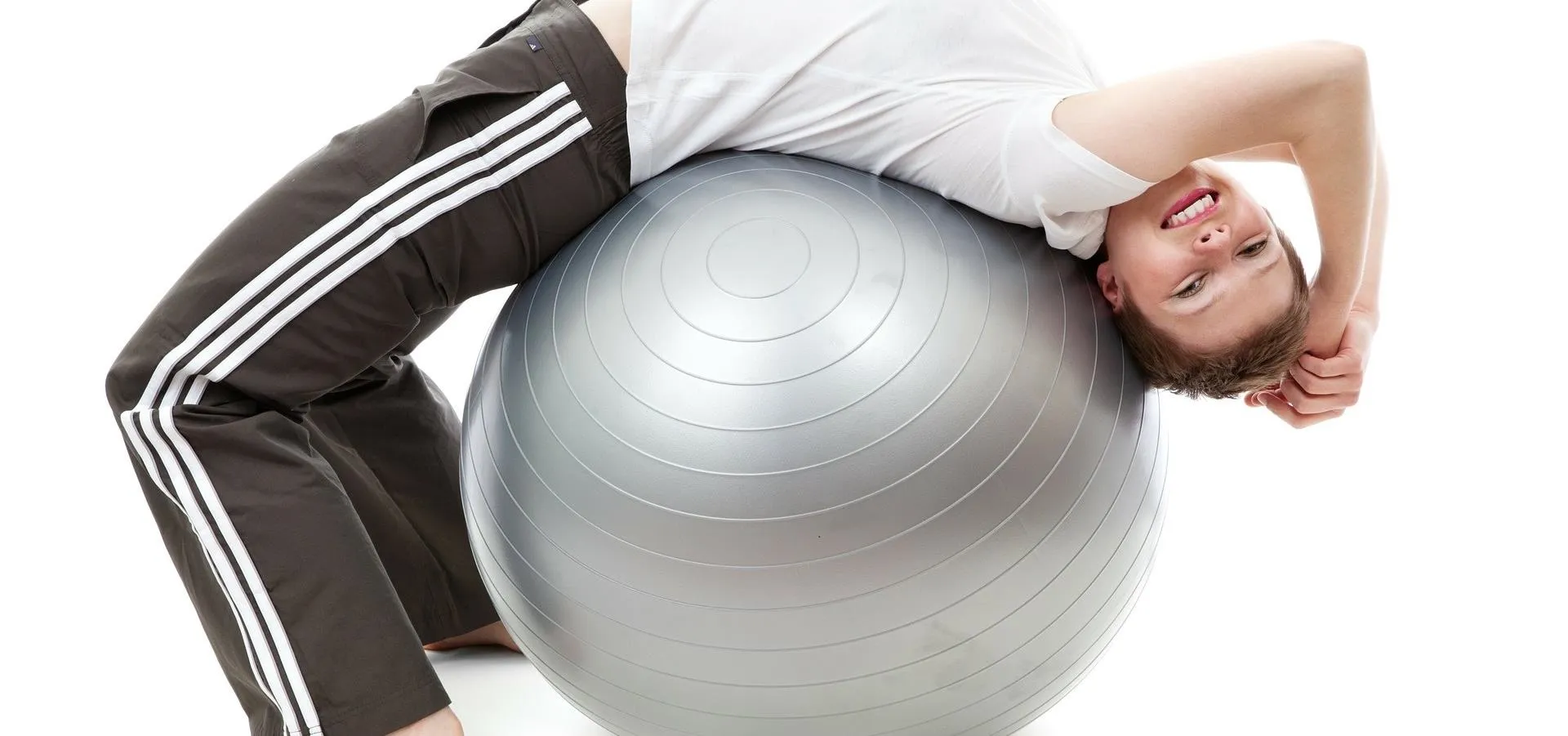 Person exercising with a stability ball.