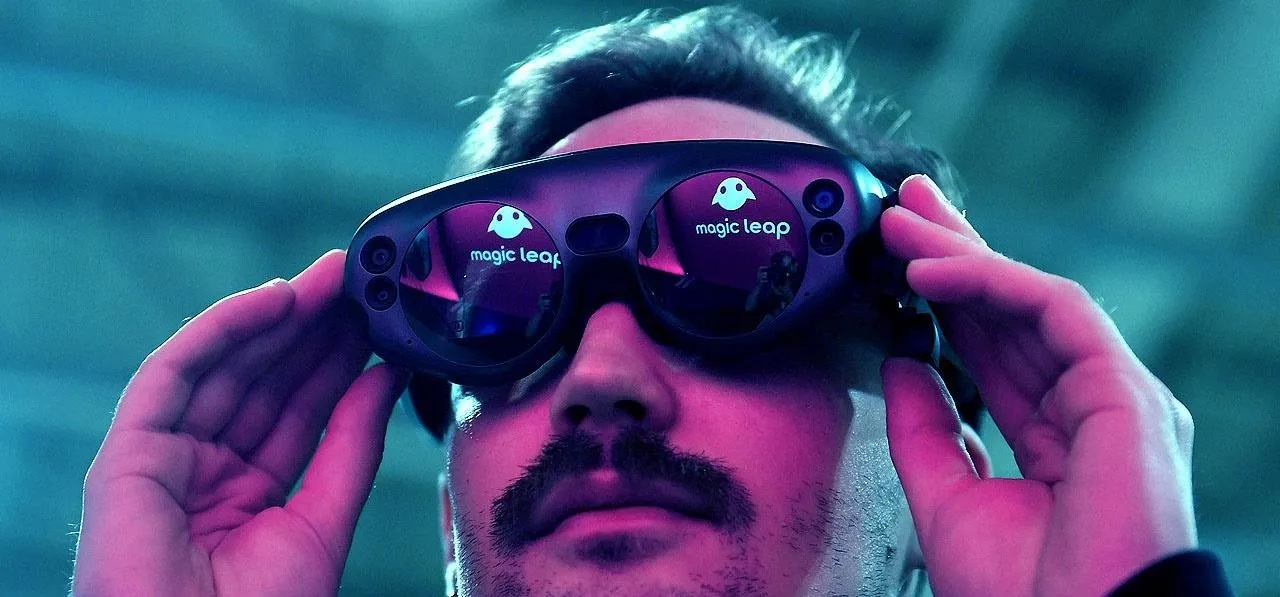 Person wearing augmented reality glasses with a futuristic design.