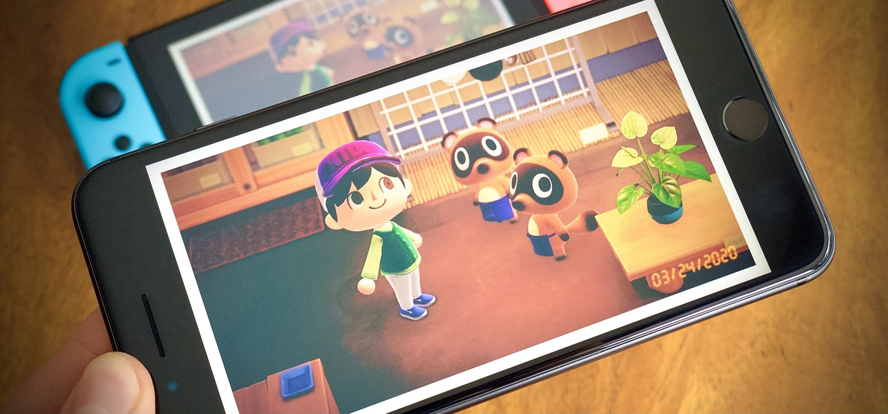"Mobile phone displaying a scene from a video game featuring anthropomorphic characters in a cozy indoor setting."