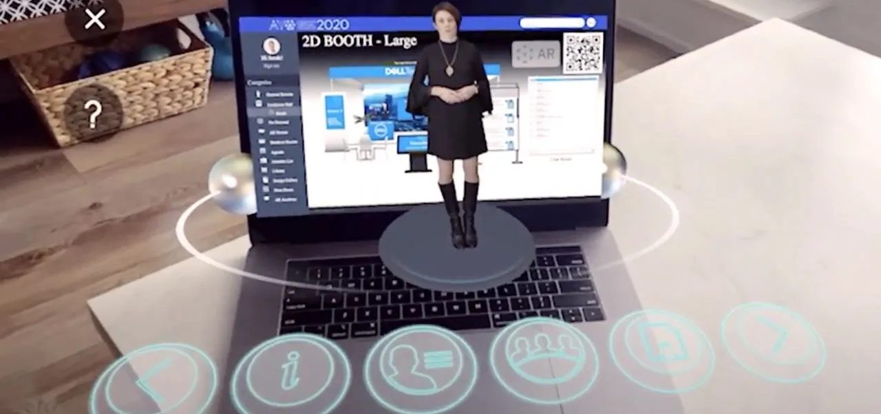 A person presenting a 3D model on a laptop using augmented reality.